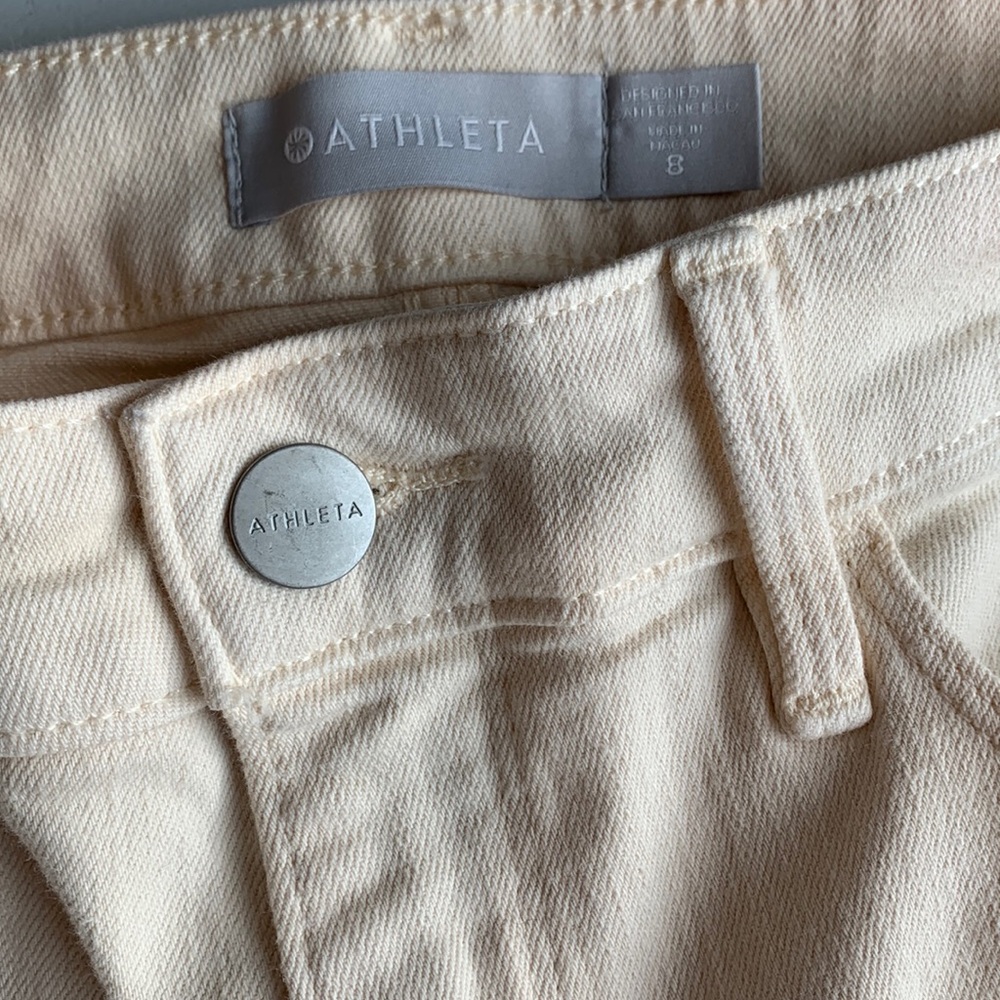 Athleta size 8 jeans in a cream/very light yellow shade.
